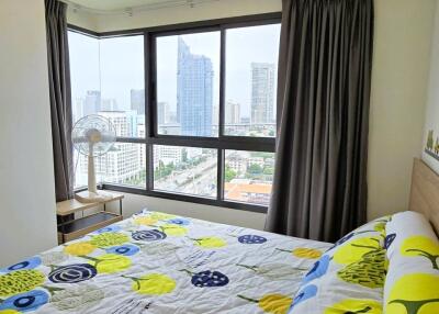 Bright bedroom with large windows and city view