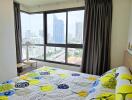 Bright bedroom with large windows and city view