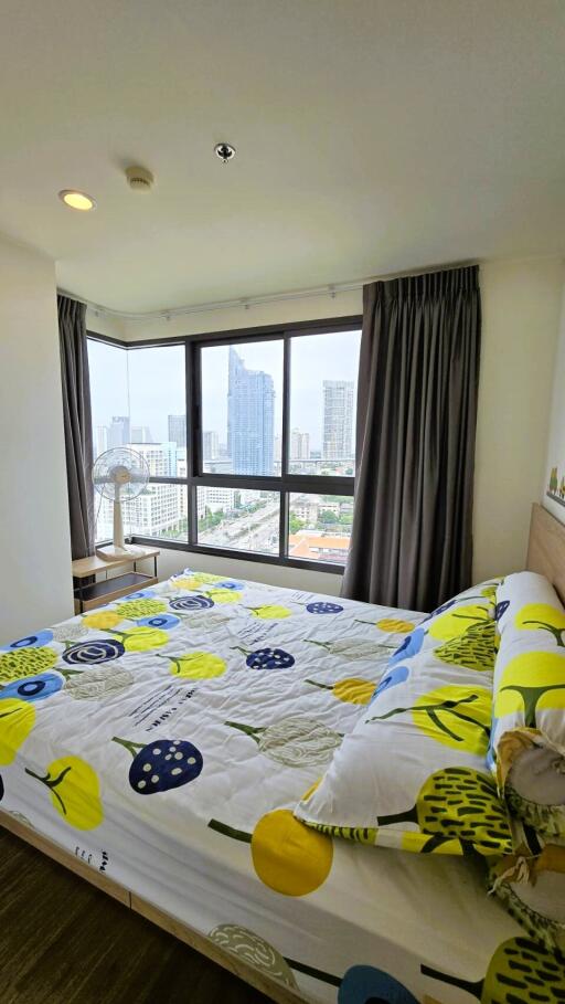 Bright bedroom with large windows and city view