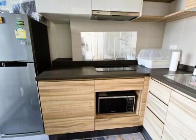 Modern kitchen with stainless steel appliances and wooden cabinets