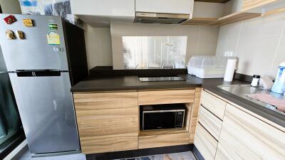 Modern kitchen with stainless steel appliances and wooden cabinets