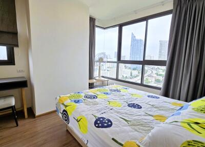 Modern bedroom with large windows and city view