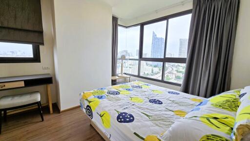 Modern bedroom with large windows and city view