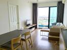 Modern living room with dining area and balcony view