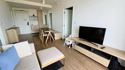 Modern living room with TV and dining area