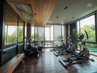 Spacious fitness center with modern exercise equipment and large windows