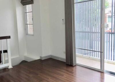 Spacious living room with wooden floors and large windows