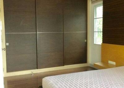 Modern bedroom with large wardrobe and bed