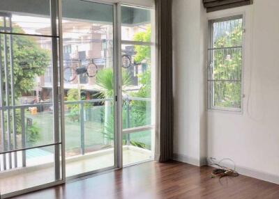 Spacious living room with large windows and balcony view