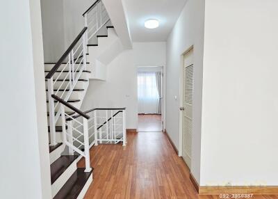 Modern hallway with wooden flooring and staircase