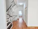 Modern hallway with wooden flooring and staircase