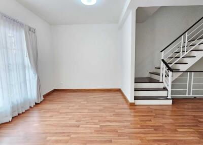 Spacious living room with wooden flooring and staircase