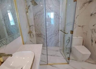 Modern bathroom with glass shower and marble tiles