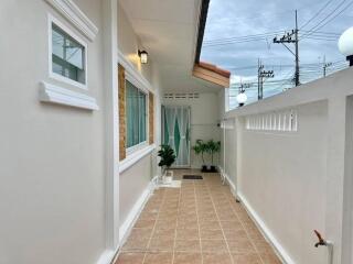 front entrance corridor with tiled flooring and greenery