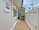 front entrance corridor with tiled flooring and greenery