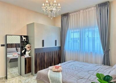 Modern bedroom with chandelier and large window