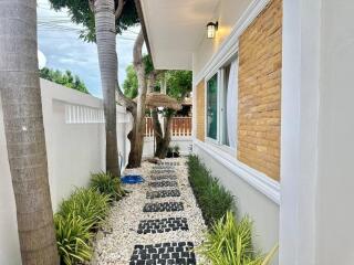 Exterior walkway with trees and stone path