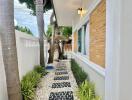 Exterior walkway with trees and stone path