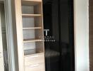 Bedroom wardrobe with open shelves and black glass doors