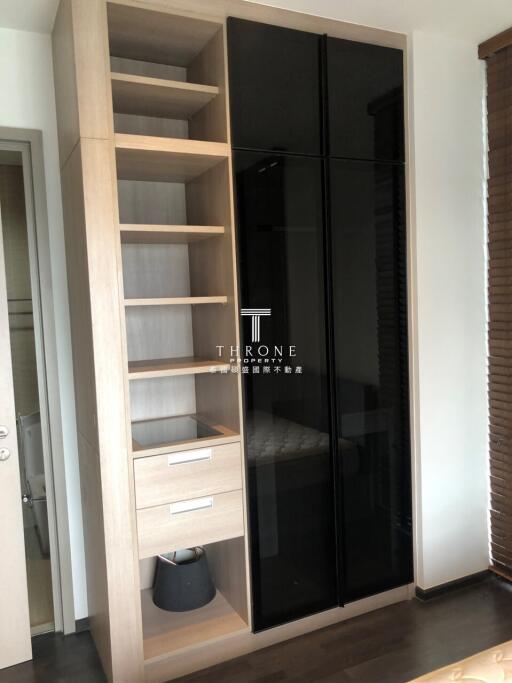 Bedroom wardrobe with open shelves and black glass doors