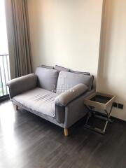 Small living area with a grey sofa and side table