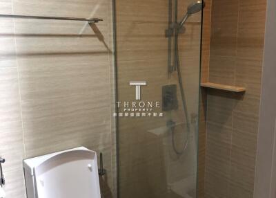 Modern bathroom with glass shower enclosure and toilet