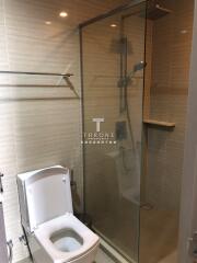 Modern bathroom with glass shower enclosure and toilet