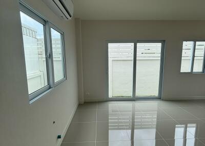 main living area with large windows and glossy tiled floor