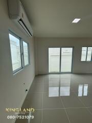 main living area with large windows and glossy tiled floor