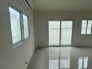 main living area with large windows and glossy tiled floor