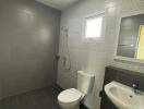 Modern bathroom with gray tiles and sanitary fixtures