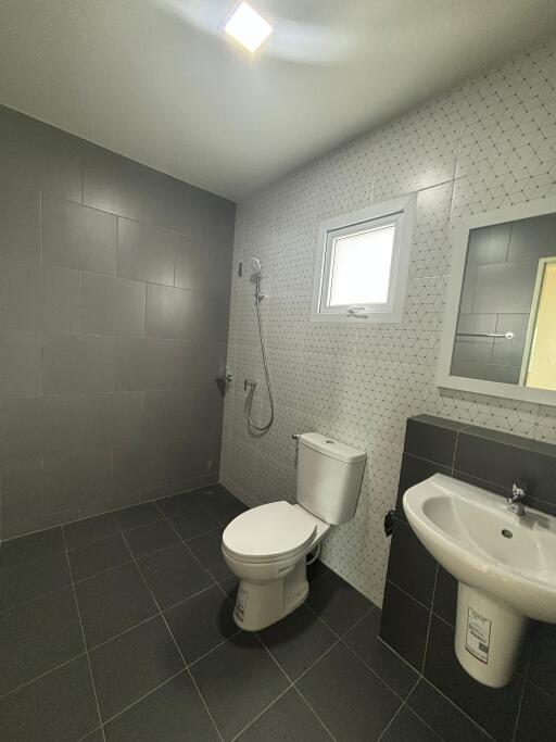 Modern bathroom with gray tiles and sanitary fixtures