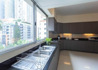 Modern kitchen with large window and city view