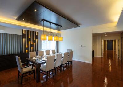 Spacious dining room with a large table and elegant lighting