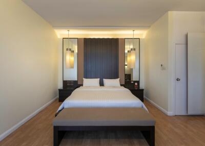 Spacious and modern bedroom with double bed and stylish lighting