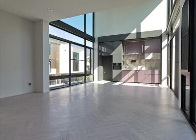 Spacious modern living room with large windows and high ceiling