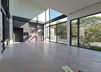 Spacious modern living room with large windows and high ceiling