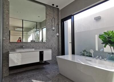 Modern bathroom with freestanding bathtub and large mirror