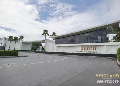 Modern commercial building with large windows and palm trees