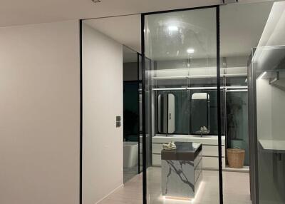 Modern bathroom with glass enclosure and minimalist design