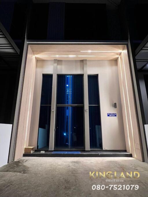 Modern building entrance at night with illuminated lights