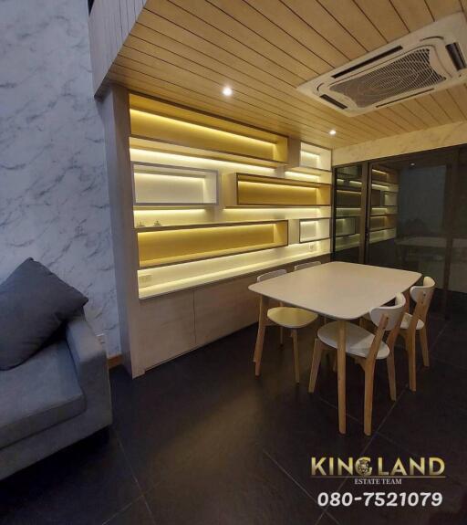 Modern dining area with unique lighting and wooden features