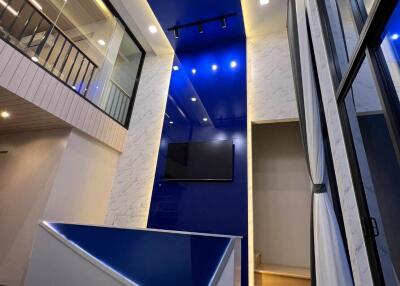 Modern living room with high ceiling and loft