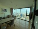 Modern living room with large windows and city view