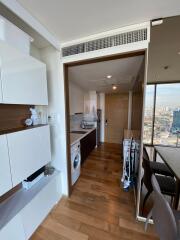 Modern kitchen with wooden floor and white cabinets