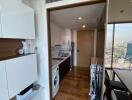 Modern kitchen with wooden floor and white cabinets