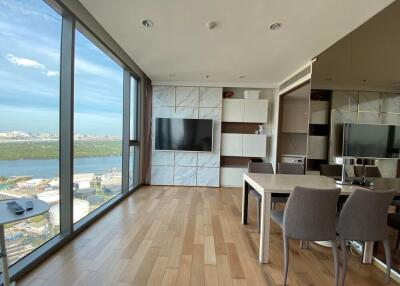 Modern living area with large windows and dining table