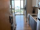 Modern kitchen with wooden flooring and a city view