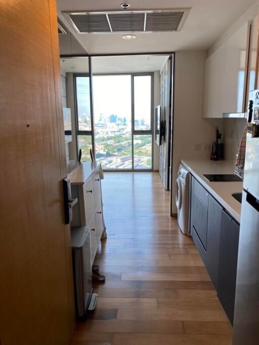 Modern kitchen with wooden flooring and a city view