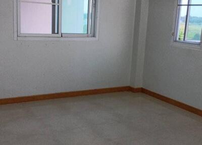 Empty bedroom with tiled floor and windows